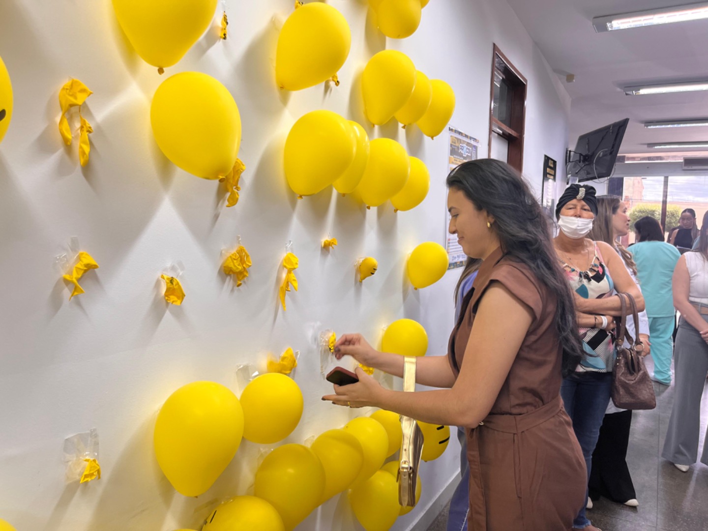Foi formado um painel com bolas amarelas e os presentes foram convidado a estourarl.jpg